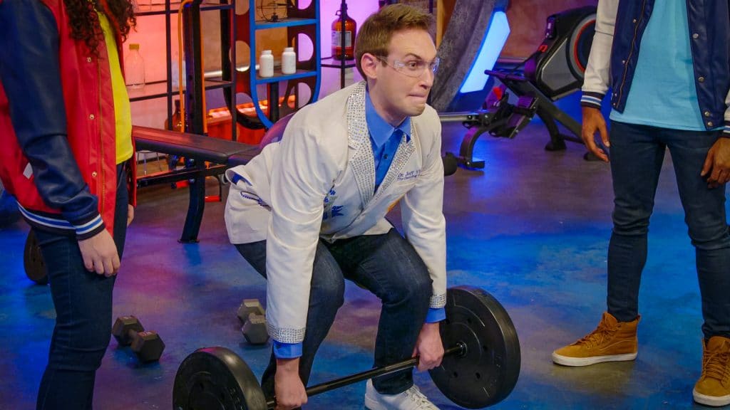 scientist lifts a weight to demonstrate use of muscles