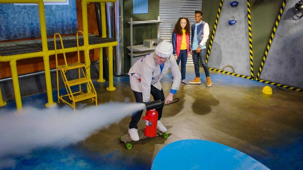 scientist demonstrates unbalanced forces using a fire extinguisher