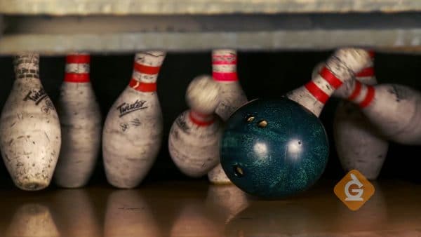 bowling ball hits pins transferring energy