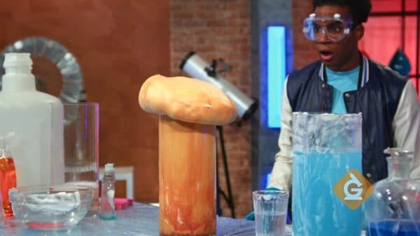 man watching an amazing chemical reaction of foam