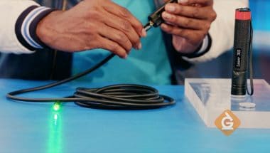 a green laser is shined through a fiber optic cable