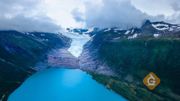 glacier seen from the air as it slides down towards the water