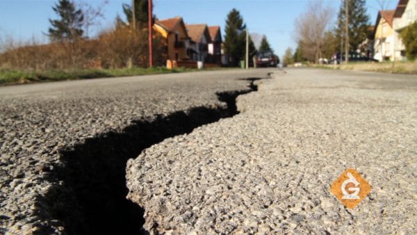 crack in the road caused by weathering