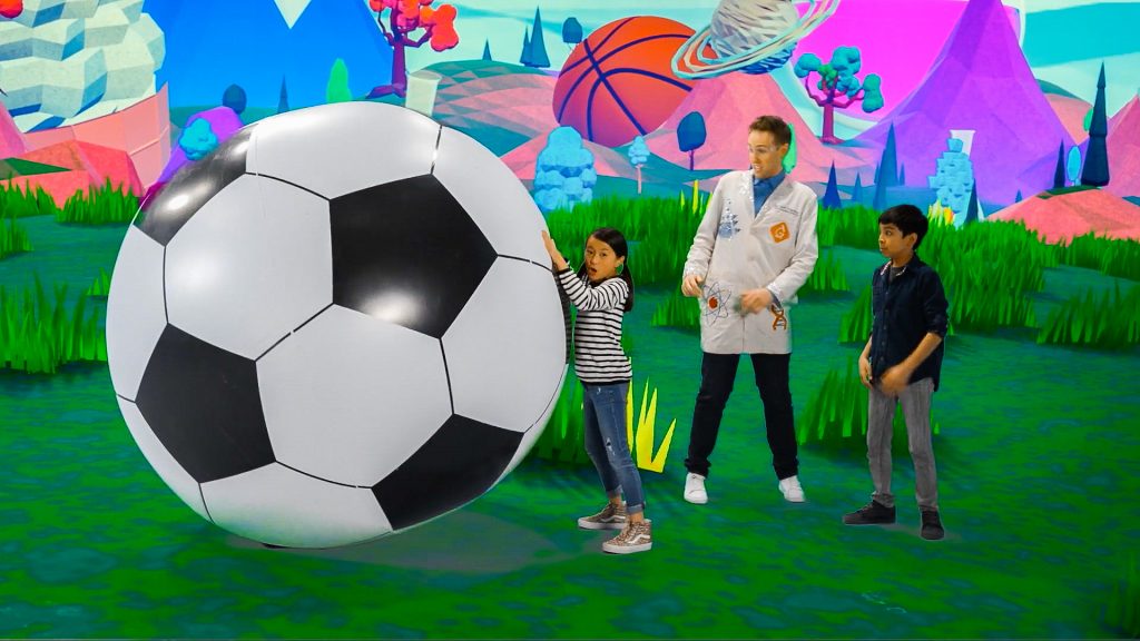 scientist and kids show how a ball can be pushed with force