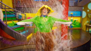 man in a plant suit gets drenched in water