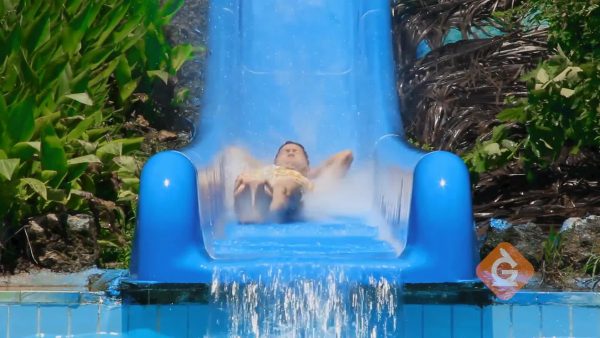 man goes down a water slide