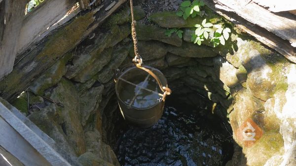 bucket in a water well collects ground water
