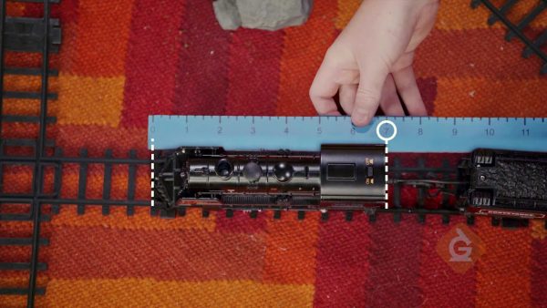 Use a ruler to measure toy trains.
